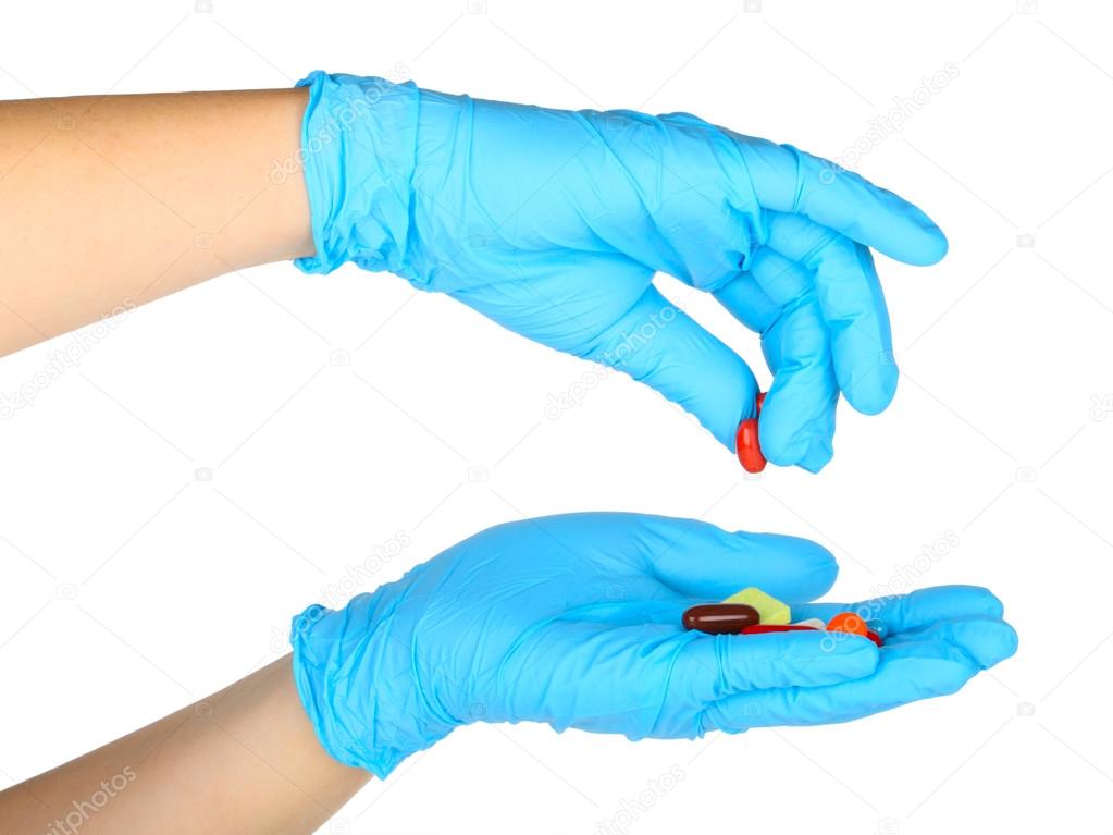 Gloved hand with pills 