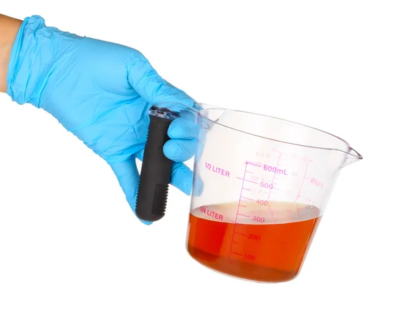 Gloved hand hold a flask — Stock Photo, Image