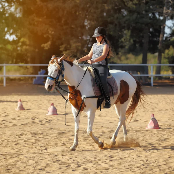 Menina está montando um cavalo — Fotografia de Stock