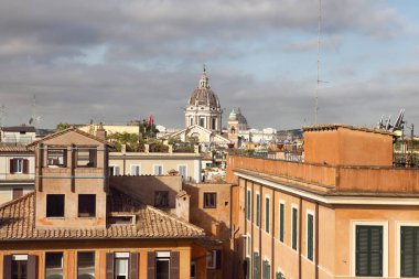 Roma, İtalya - 17 Eylül 2025: İspanyol Merdivenlerinin bu manzarası Roma 'nın tarihi merkezinin çatılarını ve Aziz Peter Bazilikası' nın kubbesini vurguluyor.