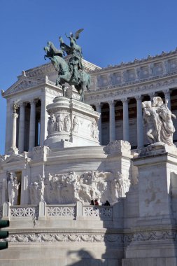 Rome, Italy - September 21, 2025: Statue of Victor Emmanuel II at the Vittoriano monument (Altare della Patria) against a clear blue sky in Rome, Italy. Iconic Roman neoclassical architecture and sculptures.
