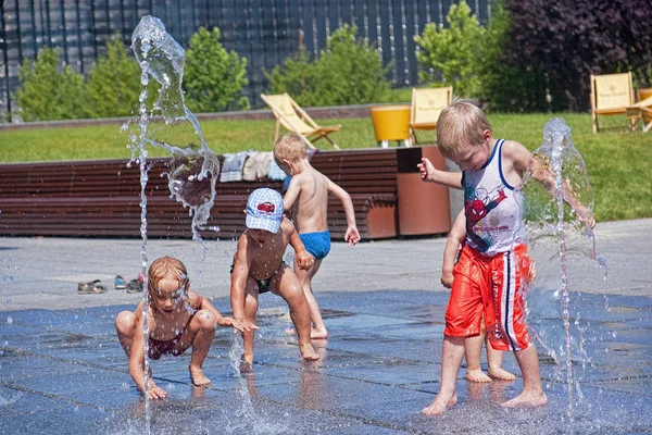 KATOWICE, POLAND - JULY 19, 2015: Children playing in the founta