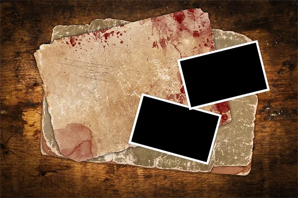 Vintage bloody papers and blank photo frames on wood — Stock Photo, Image