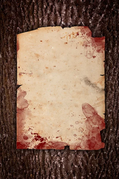 Old paper with red blood stains and spots on wood — Stock Photo, Image