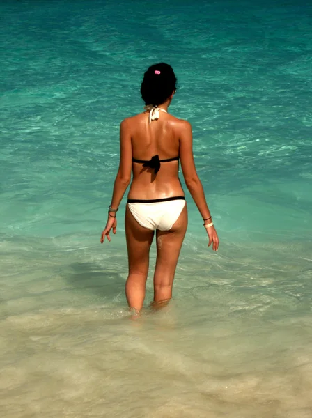 Young woman wading in the shallows — Stock Photo, Image