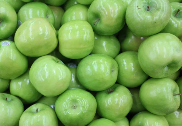 Granny Smith apples on a supermarket display Stock Picture