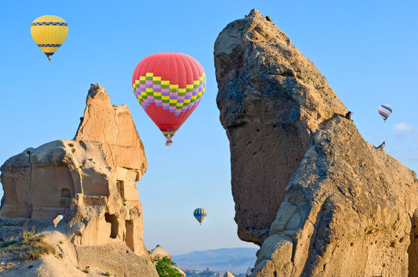 Hot air balloons over mountain landscape 