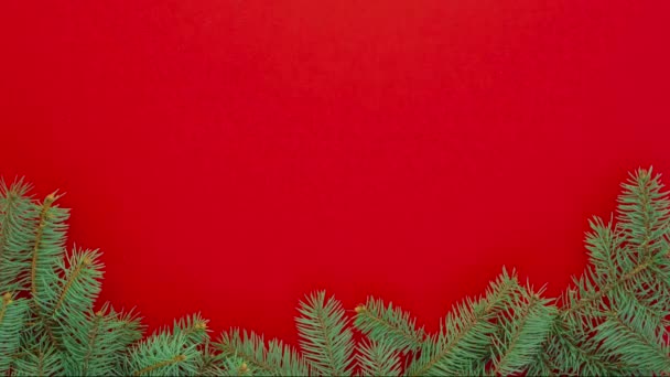 Різдвяні прикраси на ялинках на червоному тлі, зупинка анімації руху — стокове відео