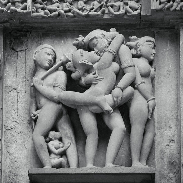 Stone carved erotic bas-relief in Hindu temple in Khajuraho, India. Unesco World Heritage Site 