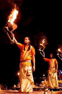 Hindu priests performs the Ganga Aarti ritual clipart