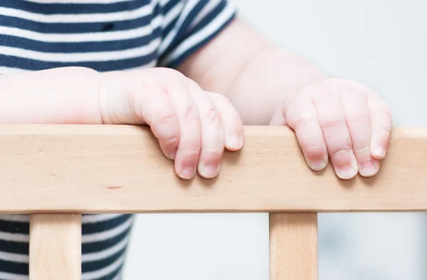 Kid's hands on a board. — Stock Photo, Image