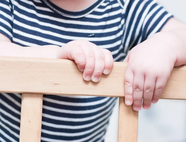 Kid's hands on a board. — Stock Photo, Image