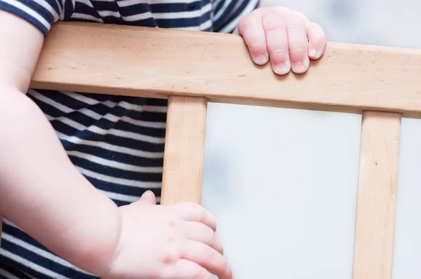 Kid's hands on a board. — Stock Photo, Image
