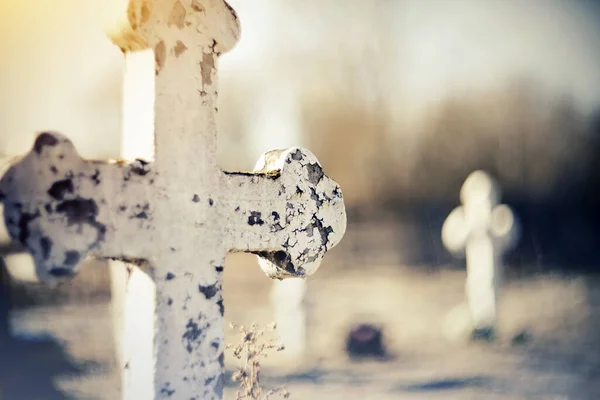 Sepulchral white old cross at the cemetery.