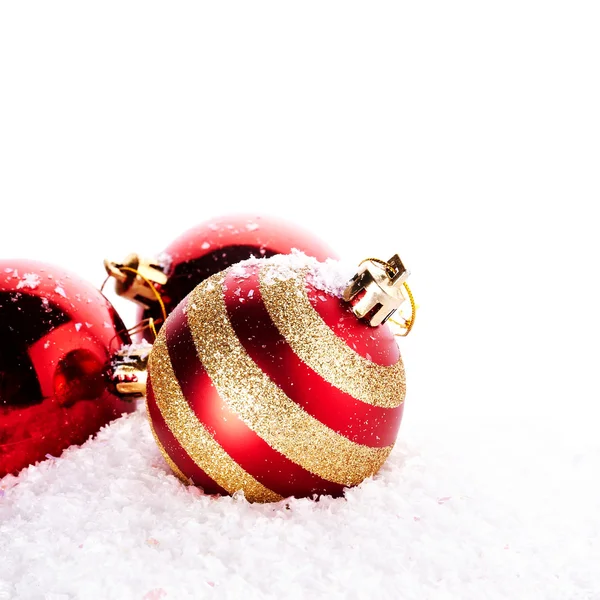 New Year's striped red balls on snow. — Stockfoto