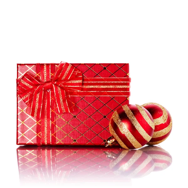 New Year's striped red balls and gift. Stock Photo