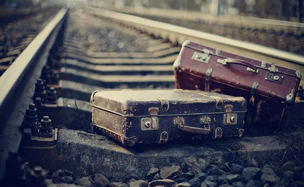 Two old fashioned a suitcases on railroad tracks — Stock Photo, Image