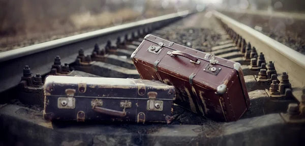 Two vintage suitcases lie on railway rails. — Stock Photo, Image