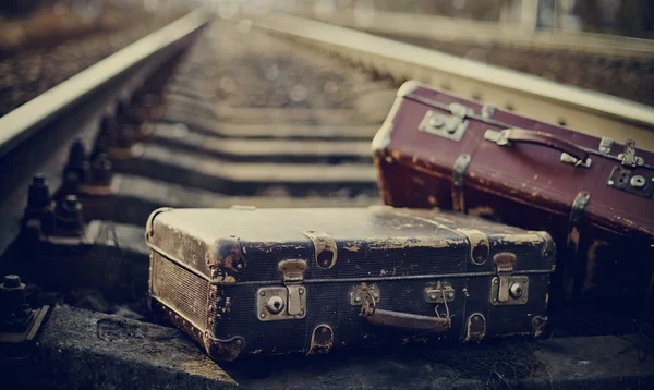 Old suitcases on railroad tracks — Stock Photo, Image