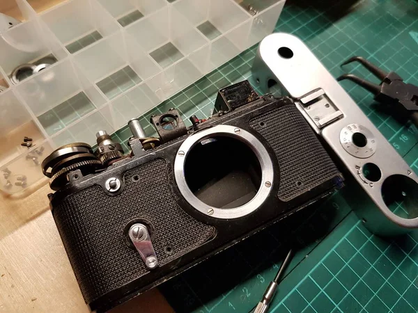 Craftsman repairing a vintage film camera
