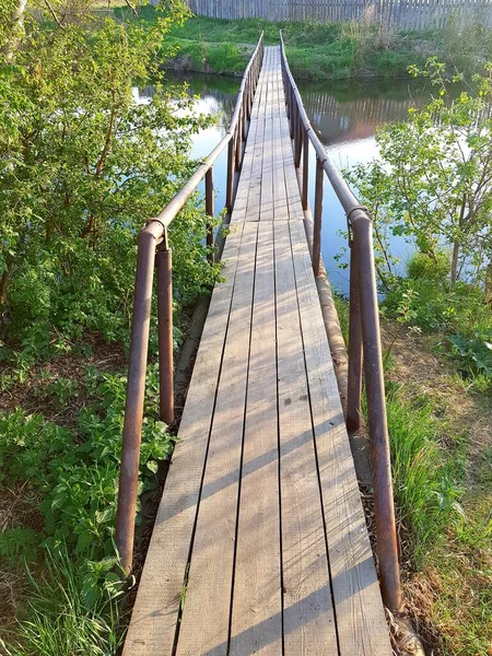 Old wooden foot bridge over the river