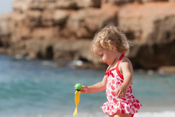 Pequeña chica bonita se baña en la piscina infantil en la costa mediterránea . — Foto de Stock