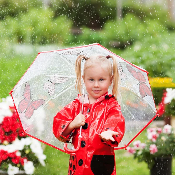 Happy fun vrij klein meisje in de rode regenjas met paraplu lopen in de zomer van het park — Stockfoto