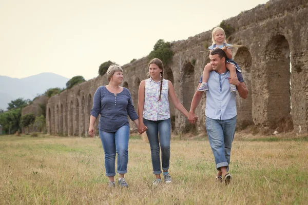 Happy family fun on field with haystacks — Stock Photo, Image