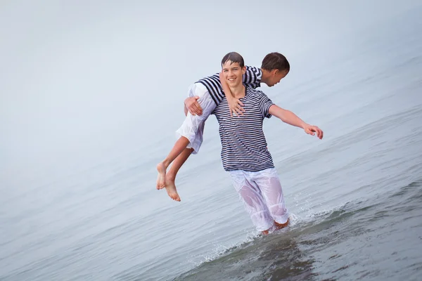 Два веселых, счастливых, брат играет в море — стоковое фото