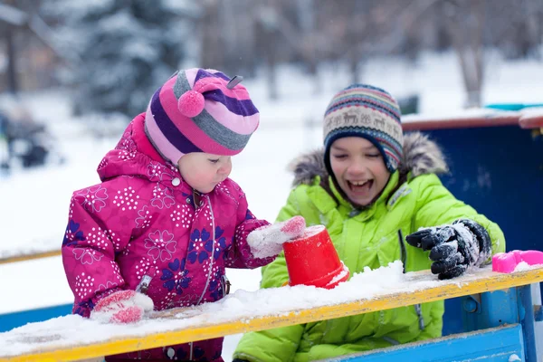 Feliz irmão e irmã brincam com neve no parque — Fotografia de Stock