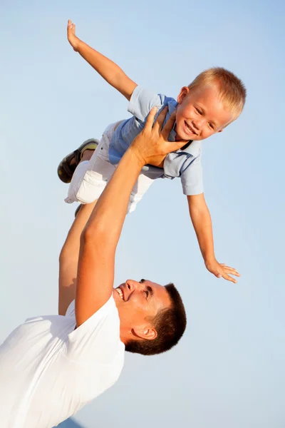 Feliz padre joven con su pequeño hijo al aire libre — Foto de Stock