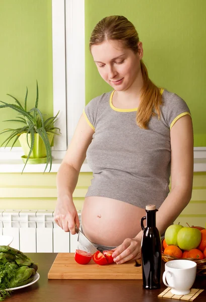 Mujer embarazada cocinando alimentos saludables —  Fotos de Stock