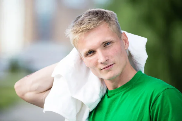 Tired man after fitness time and exercising. With white towel — Stock Photo, Image