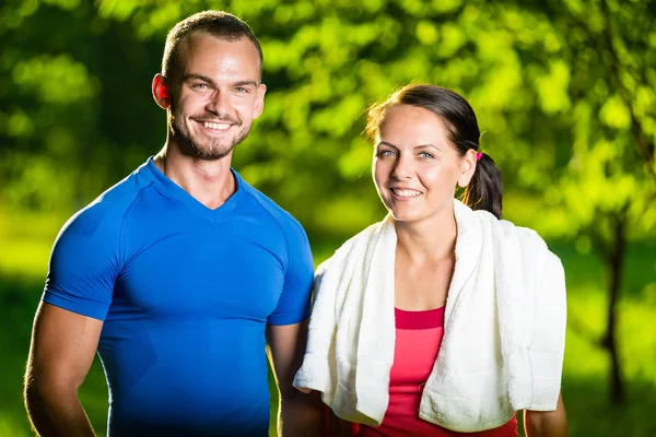 Athletic man and woman after fitness exercise — Stock Photo, Image