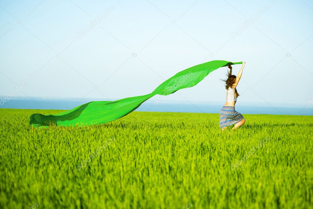 Young happy woman in wheat field with fabric. Summer lifestyle