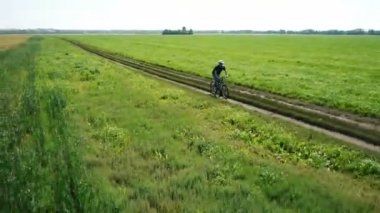 Anteni: yeşil ve sarı alan ile kırsal Road bisiklet üzerinde Bisiklete binme genç adam.