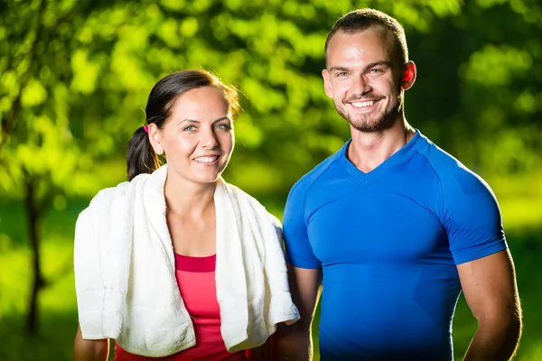 Athletic man and woman after fitness exercise — Stock Photo, Image
