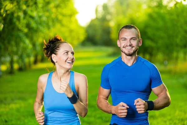 Runners training outdoors working out. City running couple jogging outside. — Stock Photo, Image