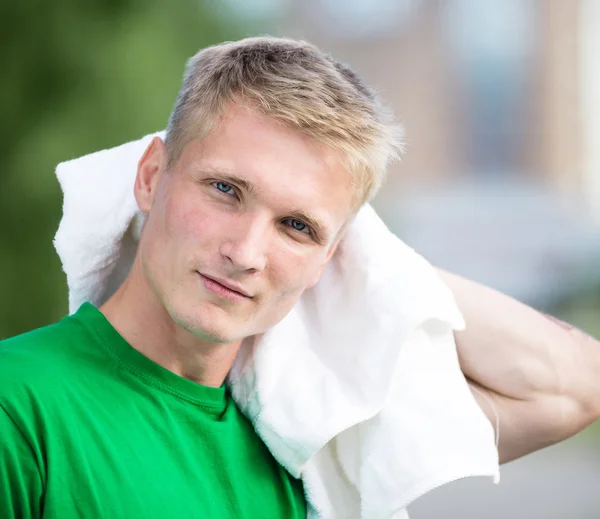 Tired man after fitness time and exercising. With white towel — Stock Photo, Image