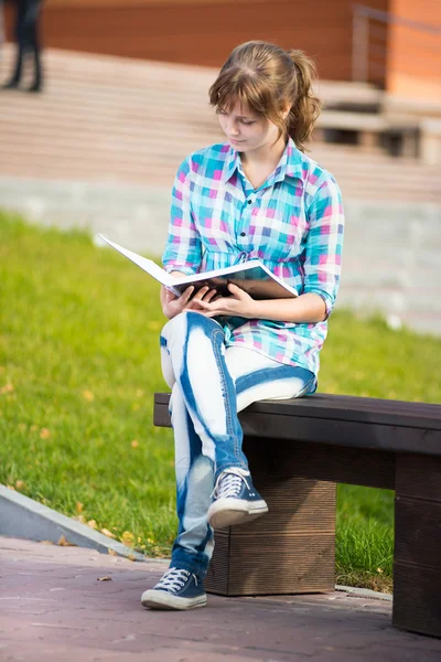 Student girl with copybook on bench. Summer campus park. — Stock Photo, Image