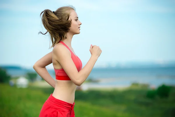 Giovane donna che gestisce il parco estivo strada rurale. Esercizi all'aperto. J — Foto Stock