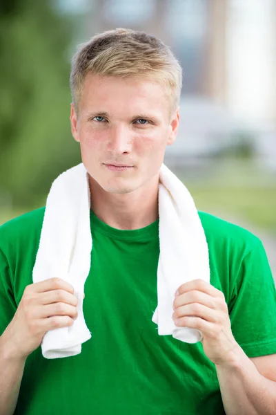 Tired man after fitness time and exercising. With white towel — Stock Photo, Image