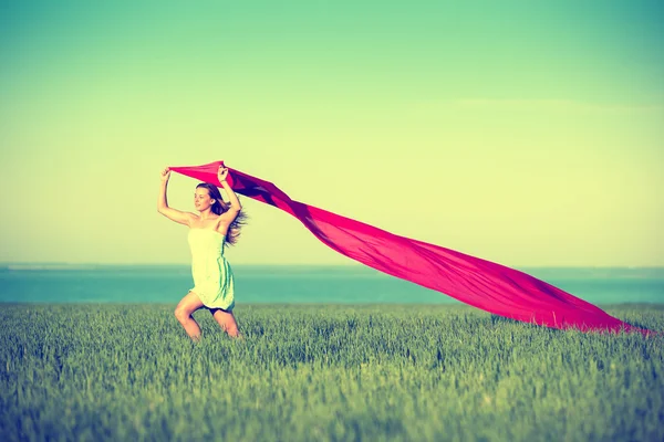 Young happy woman in wheat field with fabric. Summer lifestyle — Stock Photo, Image