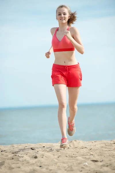 Young lady running at the sunny summer sand beach. Workout.  Jog — Stock Photo, Image