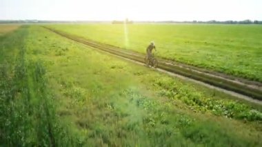 Anteni: yeşil ve sarı alan ile kırsal Road bisiklet üzerinde Bisiklete binme genç adam.