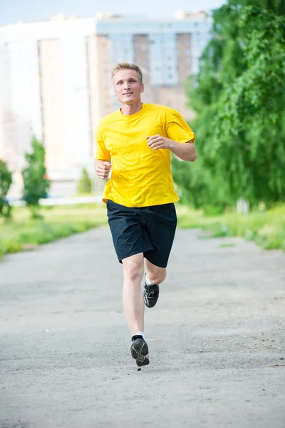 Sportieve man joggen in straat skyline van de stad. Buiten fitness. — Stockfoto