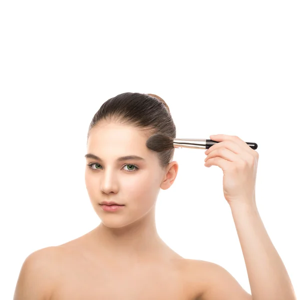 Young brunette woman with clean face. Girl perfect skin applying cosmetic brush. Isolated on a white. — Stock Photo, Image
