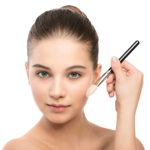 Young brunette woman with clean face. Girl perfect skin applying cosmetic brush. Isolated on a white. — Stock Photo, Image