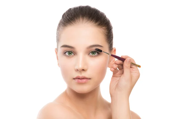 Young brunette woman with clean face. Girl perfect skin applying cosmetic brush. Isolated on white. — Stock Photo, Image