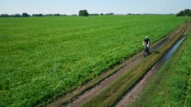 Anteni: yeşil ve sarı alan ile kırsal Road bisiklet üzerinde Bisiklete binme genç adam.